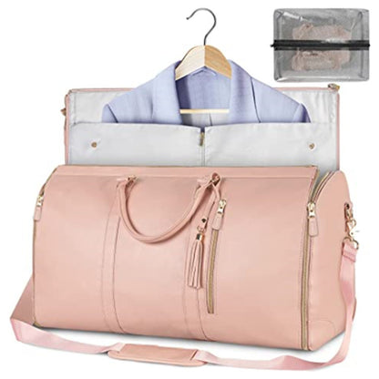 Pink foldable travel bag bag with clothes and a hanger on a white background