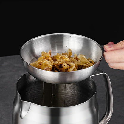 Stainless steel strainer with food being used over a pot, on a dark background.