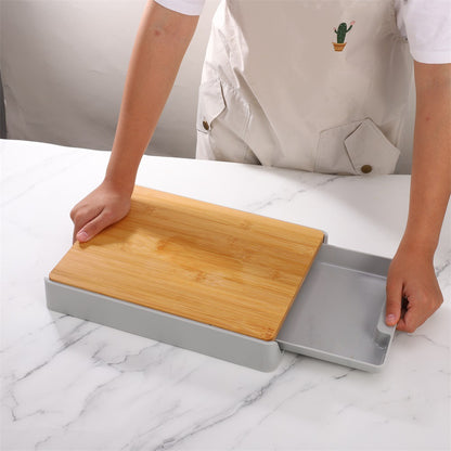 Person using a wooden cutting board on a marble surface