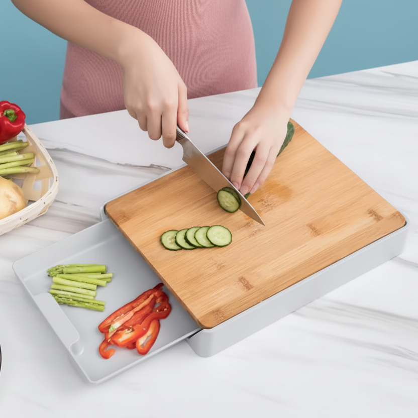 Person slicing vegetables on a bamboo cutting board with a blue background